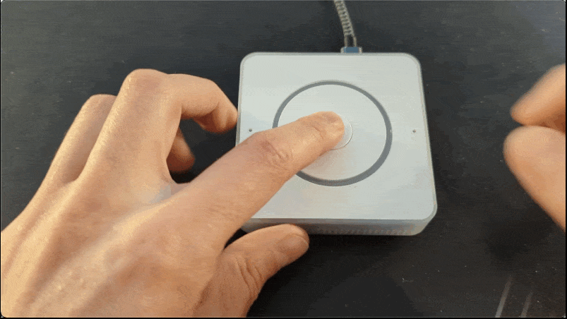 Image showing a hand pressing the central button